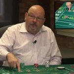 What is the Iron Cross betting strategy in craps?