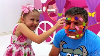 Nastya and dad play with lego toys